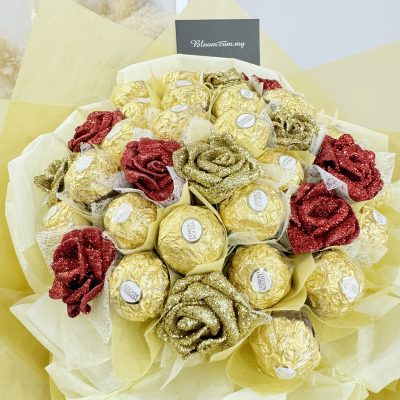 close-up of glittery red and gold roses with ferrero rocher chocolates, arranged neatly in pastel yellow wrapping for a luxurious gift design.