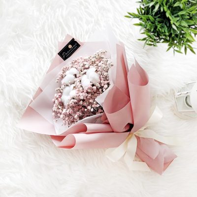 sweet bouquet of pink baby’s breath, cotton flowers in a pink wrapper.