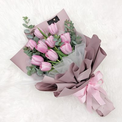 bouquet of 10 stalks pink tulips and eucalyptus in a elegant wrapper.