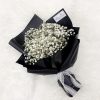 bouquet of white baby’s breath wrapped in black wrapper with white lace ribbon.