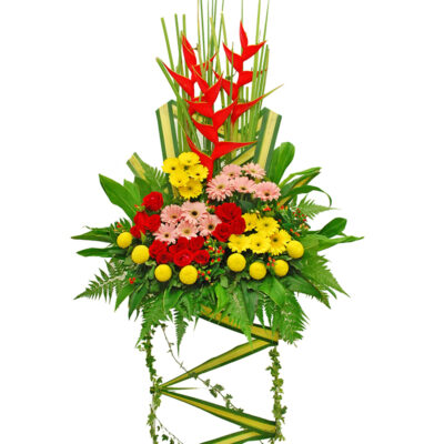opening flower stand arrangement with red crab flowers, red roses, pink and yellow gerberas, chrysanthemum ping pong and lush green leaves