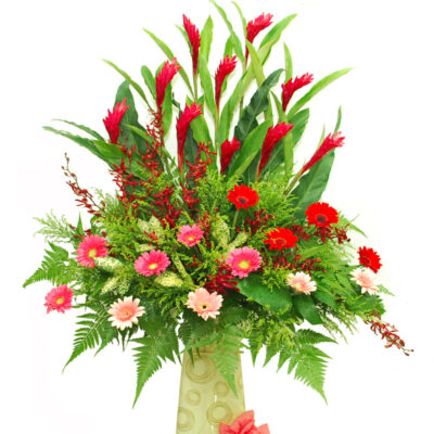 opening flower stand featuring red ginger spikes, mixed colour gerbera and orchid accents arranged in a tall floral stand with lush greenery about 185cm high.