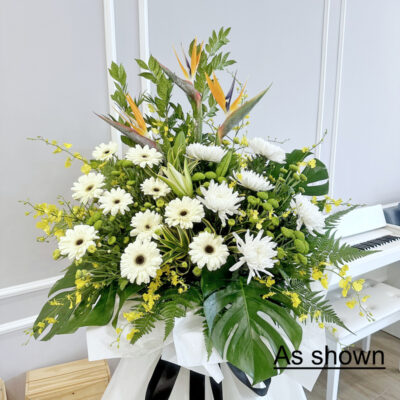 funeral flower stand with bird of paradise, white gerbera, chrysanthemum pompom and yellow orchids
