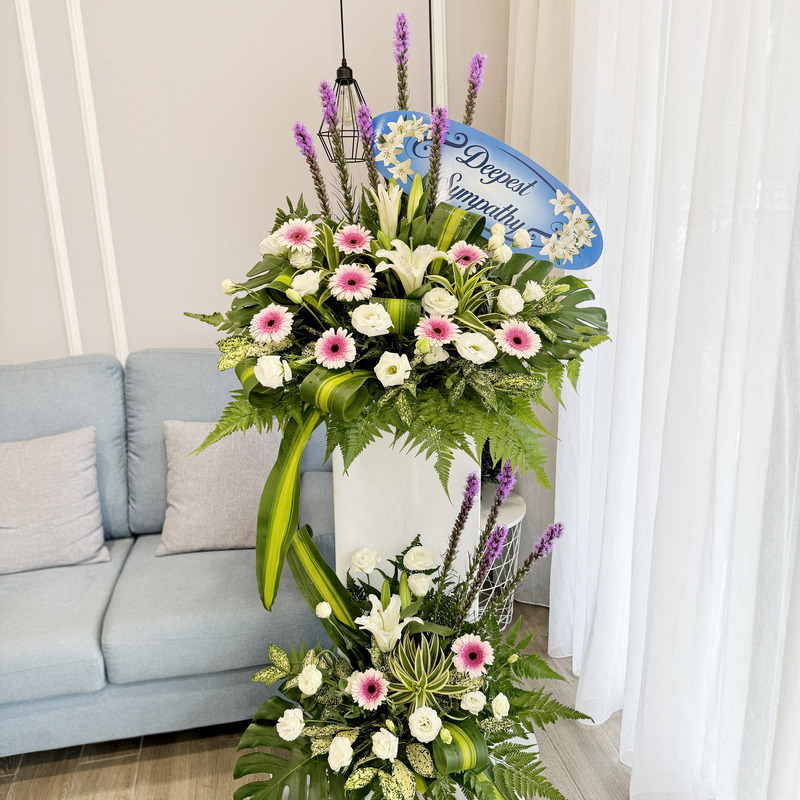 flower stand of funeral displays pink gerbera, white eustoma, liatris and casablanca lily