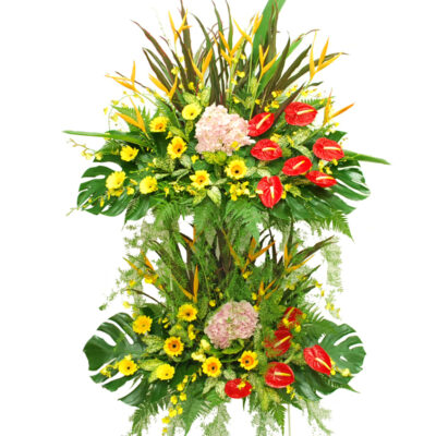 grand opening flower stand with red anthurium, yellow gerbera, pink hydrangea, heliconia and lush green leaves arranged in two tiers.