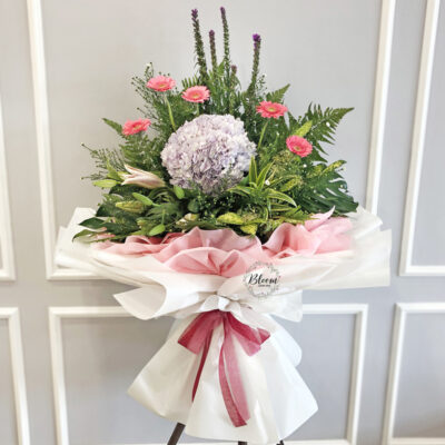 congratulation flower stand featuring pink gerbera, hydrangea, stargazer lily and liatris wrapped in white and pink paper